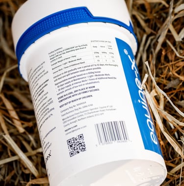A tub of the horse supplement CONNEXION on top of horsehage haylage