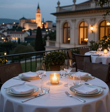An elegant outdoor dining scene at a luxury villa overlooking a historic European city at night. Silverware and fine china reflect the warm candlelit atmosphere. Sophisticated and high-end international mood.
