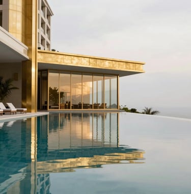 A professional architectural photograph of a sleek, modern infinity pool at a luxury hotel, reflecting a light grey sky and surrounding gold decor. North American / International context.