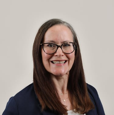 Professional headshot of Christine Masters-Wheeler, a woman with glasses and long brown hair.