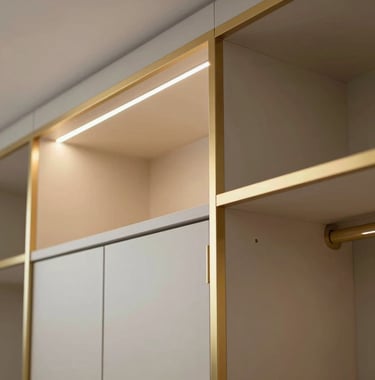 A close-up of a high-end interior detail, featuring gold-trimmed cabinetry and designer lighting in a luxury Netanya apartment.