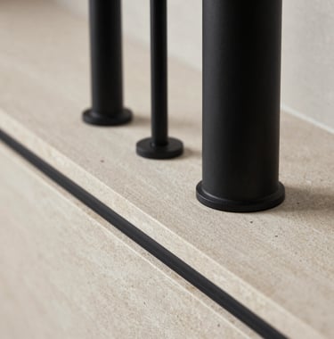 Close-up detail of a premium interior renovation, featuring matte black fixtures against a light stone surface, modern and minimalist aesthetics.