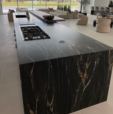 a kitchen island with black carerra marble counter top protected by top guard elite film 