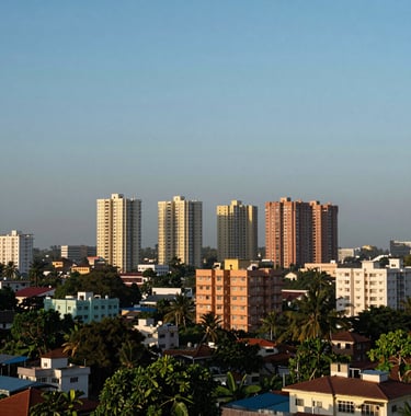 A wide shot showing the surrounding urban landscape of Moulivakkam, featuring residential towers in the distance under a clear soft blue sky.