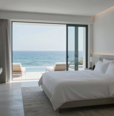Professional photography of a minimalist master suite in a coastal villa, crisp linens, Atlantic breeze through open windows, serene and sophisticated atmosphere, palette including #B4C5CB.