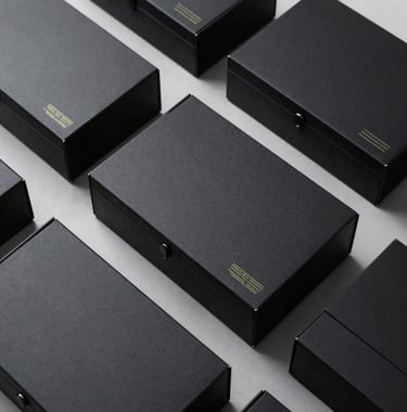 Custom high-tech black mailer boxes featuring minimalist lines, crisp clean geometric arrangement, subtle cyber yellow cybernetic branding, top-down product layout photo.