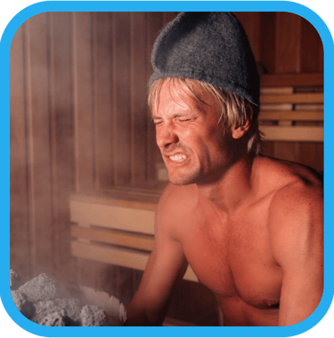 a man in a sauna with a sauna hat grimacing