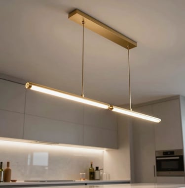 Elegant low-angle shot of designer pendant lighting fixtures hanging over a sleek kitchen workspace, emphasizing modern architectural lines and champagne gold finishes.