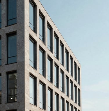 A minimalist architectural detail of a modern Luxembourg office building. Clean lines of limestone and glass reflecting a pale blue sky. Sophisticated, quiet, and premium aesthetic.