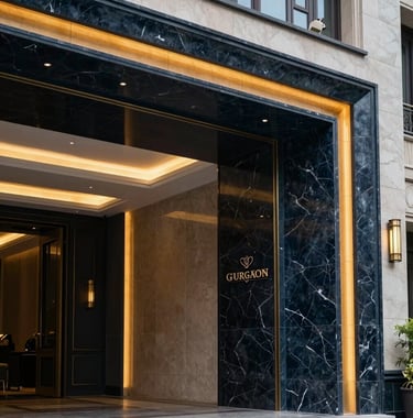 Close-up architectural shot of a luxury clubhouse entrance in a premium Gurgaon sector, featuring marble walls, warm recessed lighting, and a sophisticated navy and gold aesthetic.