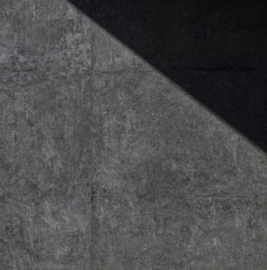 A high-contrast photography of a heavy, dark-grey textured concrete wall with a single sharp shadow falling diagonally across it. The composition is minimalist and architectural, conveying a mood of absolute control and stability in a North American / International Business context.