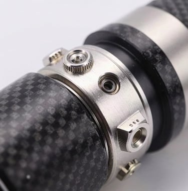Macro photography of high-quality metallic silver components and dark charcoal carbon fiber, representing advanced technology and manufacturing excellence, clean studio lighting.