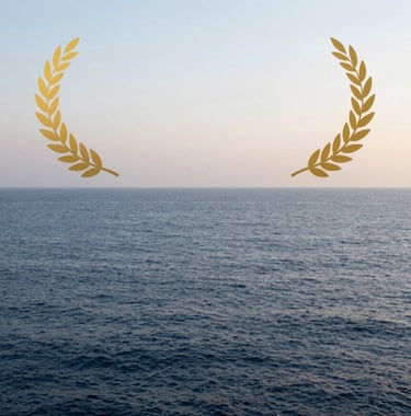 A conceptual photograph of a calm sea at dawn, where the water is a deep slate blue and the sky is a very light soft mist white, representing emotional regulation and clarity.