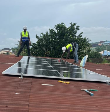 Technician installing solar panels on a rooftop