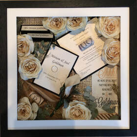 a photo of a large size memory box with preserved flowers and keepsakes from a wedding day