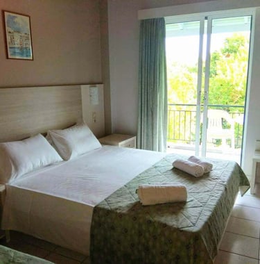 a bed room with a bed and a balcony