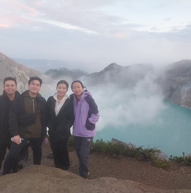 a group of people standing on a mountain top