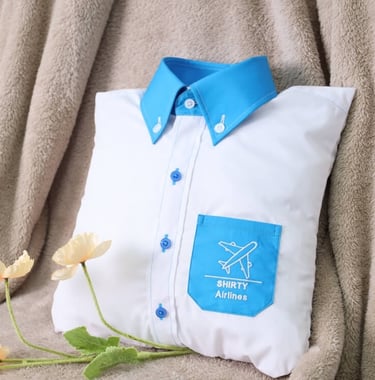 a white pillow designed as shirt with blue collar and pocket