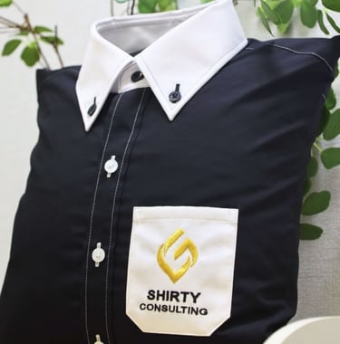 a black shirt with white collar and pocket as pillow