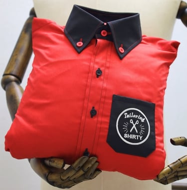 a red shirt with black collar and pocket as pillow