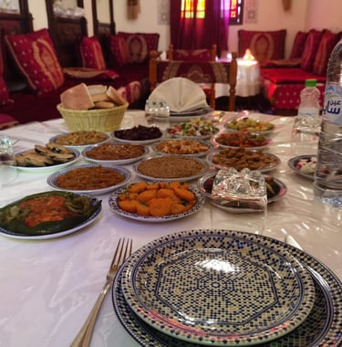 a table with plates of food and drinks
