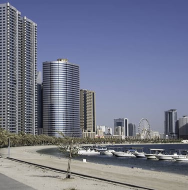 a city street with boats and buildings in the background