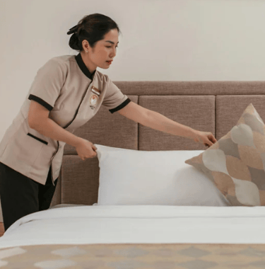 "Professional housekeeping preparing a bedroom as part of Vision Immo Bali’s property management