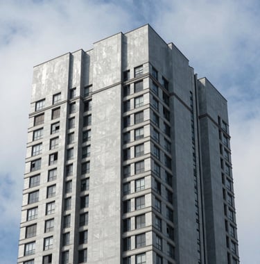 A sharp architectural photograph of a completed luxury building facade in a South American / Brazilian city, clean lines, professional composition, with Soft Steel Blue and Ice White sky tones.
