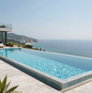 A sleek, infinity-edge swimming pool overlooking a coastal landscape, integrated into a modern architectural terrace.