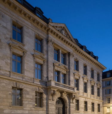 A twilight shot of a classic Geneva building façade renovated with modern minimalist style. Elegant stone textures and night blue evening sky. Professional real estate photography.
