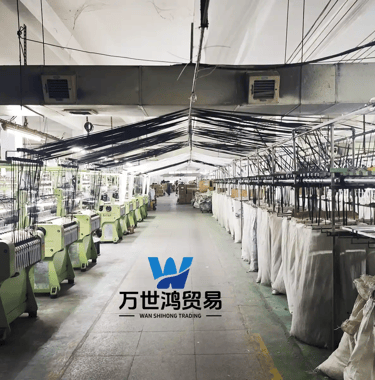 An industrial textile manufacturing plant equipped with automated weaving machinery and rows of zipp