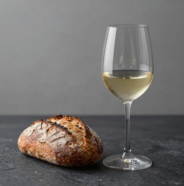 A minimalist glass of premium wine and artisan bread on a dark textured table, evoking a sense of high-end culinary excellence and sophisticated distribution.