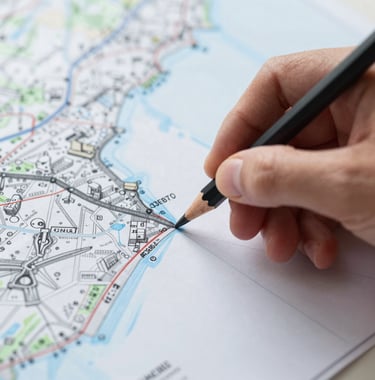 A detailed close-up of a hand-drawn map being marked with a pencil, focused and professional atmosphere, high-quality paper texture, using #3E6B7A and #1C2C39.
