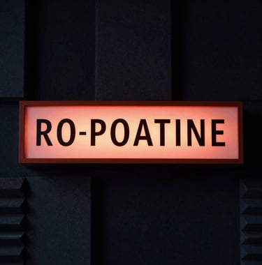 A striking photograph of a retro broadcast studio on-air sign glowing in warm terracotta red inside a dark, sophisticated acoustic room. Soft shadows in deep navy, conveying a quiet, focused archive environment.