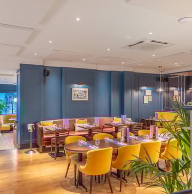 a restaurant with a large table and chairs