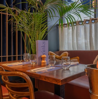 a restaurant table with a bottle of champagne and a bottle of champagne