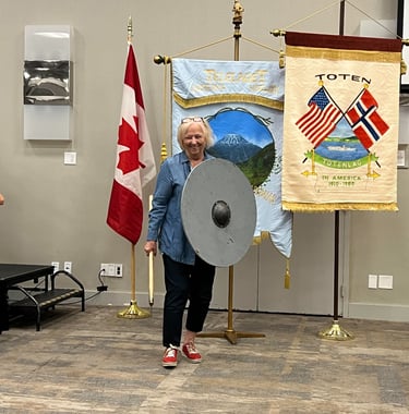 a woman and a child demonstrating viking weapons