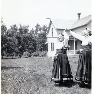 two women in bunad dancing, black and white