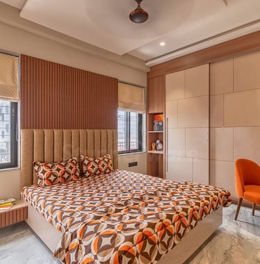 a bedroom with a bed and a desk with a chair