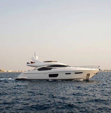 A luxury yacht sailing past the Bluewaters Island wheel in Dubai, with dark navy blue water and a soft off-white sky, capturing the high-end Middle Eastern / Gulf lifestyle.