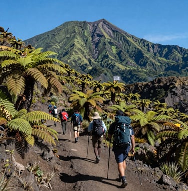 A group of active hikers with trekking poles traversing a scenic trail lined with lush volcanic ferns and local Lombok flora on the slopes of Mount Rinjani. Majestic green volcanic peaks tower in the background under clear blue skies, professional Indonesian Eco-Tourism style.