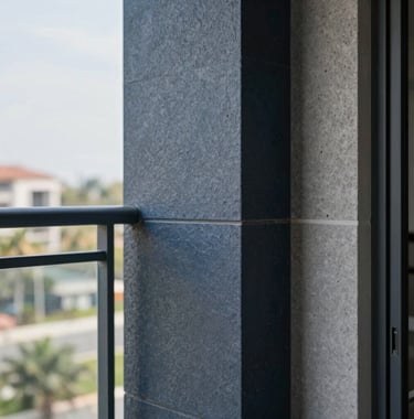 A detailed close-up of premium building materials and modern balcony finishes on a newly completed Shivam Builders project, showing sophisticated dark blue and gray textures.