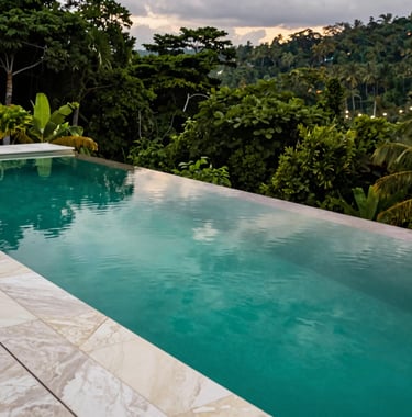 A close-up photograph of a luxury infinity pool edge in Costa Rica, where the water perfectly reflects a vibrant tropical emerald green sky at dusk. The poolside deck is made of elegant creamy off-white marble, contrasting with the deep obsidian green of the surrounding jungle canopy.