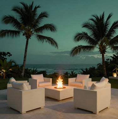 A serene twilight view of a sustainable luxury terrace in a Central American / Costa Rican coastal estate. Low-profile furniture in elegant creamy off-white is arranged around a fire pit, with silhouettes of palm trees against a deep obsidian green background and soft misty sage green lighting.