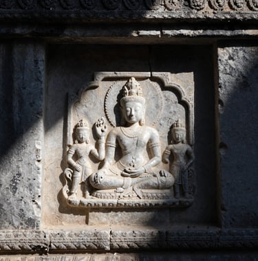 High-contrast photography of weathered, ancient stone textures in a remote temple. The lighting is dramatic, casting deep navy night shadows across pearl white stone carvings. Close-up composition focusing on the tactile quality of history.