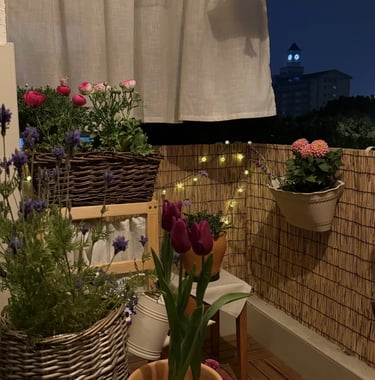 Cozy balcony with warm ambient lighting and natural wooden textures, inspired by warm European outdoor living
