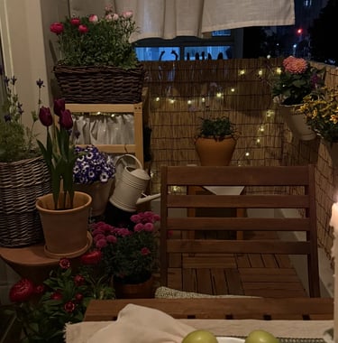 Cozy balcony with warm ambient lighting and natural wooden textures, inspired by warm European outdoor living