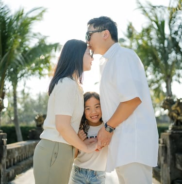Family embracing together in the tropical gardens of InterContinental Bali Resort Bali