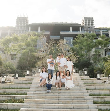 Large family walking down the iconic staircase at The Apurva Kempinski Nusa Dua during a Bali family photography session