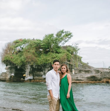Wide scenic portrait of an intimate couple at Tanah Lot Bali.